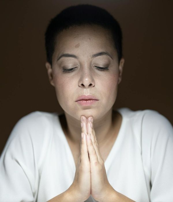 Woman with calm expression focusing, symbolizing visual clarity.